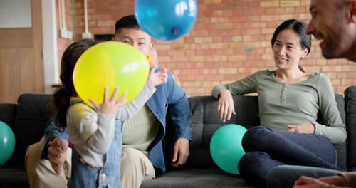 Happy Family Celebrates with Balloons at Home