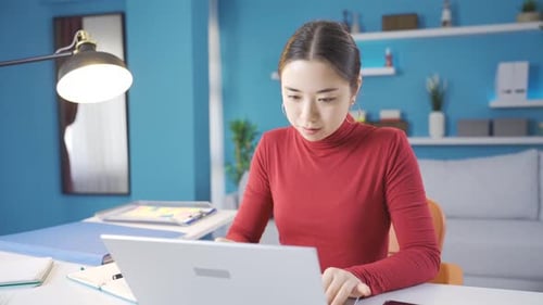 Young Adult Working at her Desk at Home