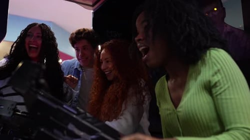 Friends Playing Arcade Game in Slow Motion