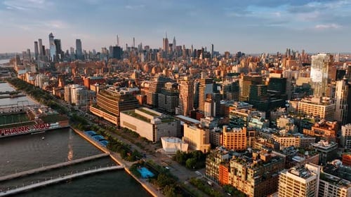 Bright cityscape of amazing New York at sunset. Drone footage above the Hudson River.