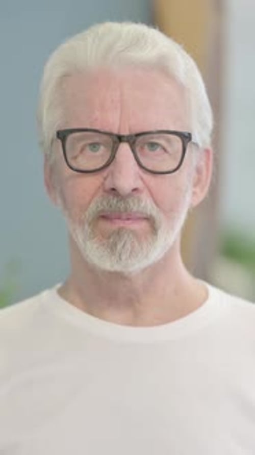 Senior Man with Glasses Looking Directly at Camera