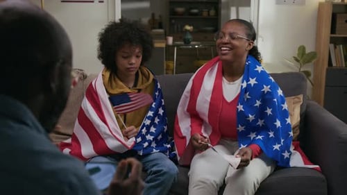 Family Celebrates with Flags and Phone Recording