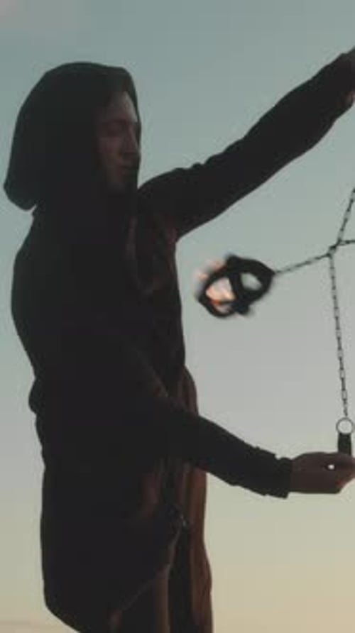 Fire Dancer Performing at Sunset