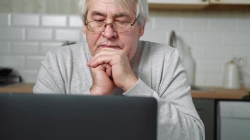 Mature Man Using Laptop at Home