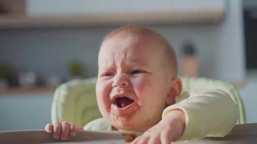 Baby Cries While Sitting in a Highchair