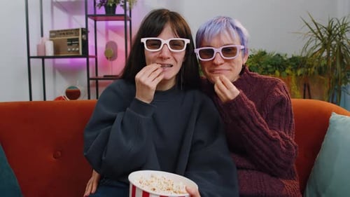 Two Friends Watching a Movie With 3D Glasses