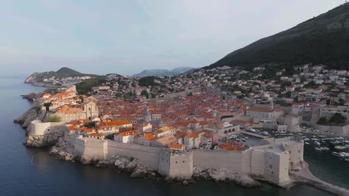 Coastal City With Orange Rooftops and Fortress