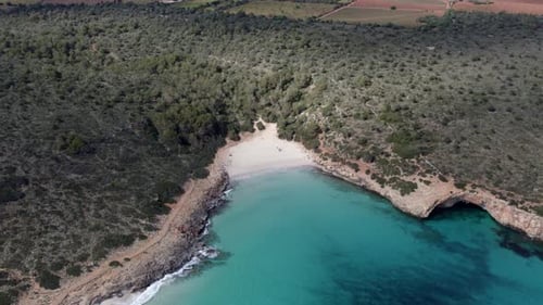 Aerial view of serene beach and clear blue water, Spain.