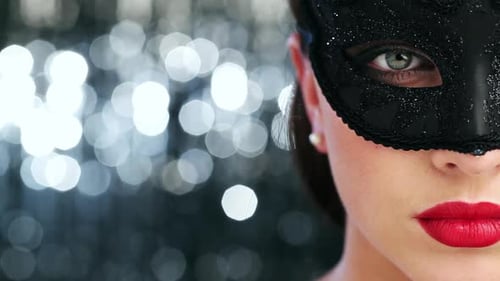 4k video footage of a sensual young woman wearing a mask against a studio background