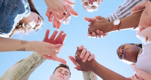 Blue sky, friends and people holding hands in circle for bonding, community and solidarity outdoors