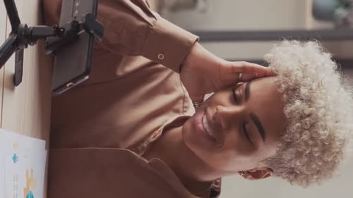 Young Woman Video Conferencing at Desk