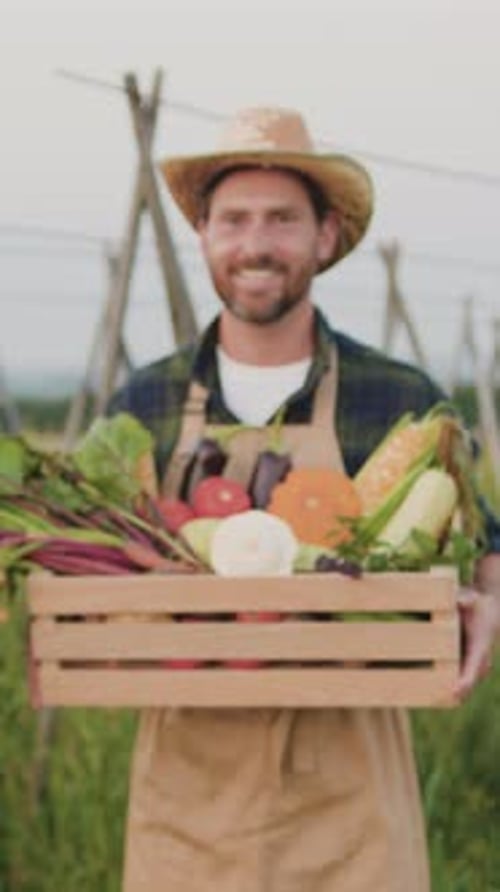 Portrait of Happy Smiling Agriculture Worker Looking at Camera and Smiling While Standing in Field