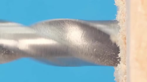 Closeup of a Wood Drill Rotating The Screwdriver Chuck Holds a Sharp Shiny Metal Bit Vertical Video