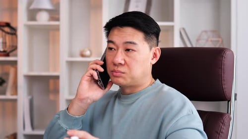 Man Talking on Cell Phone Indoors