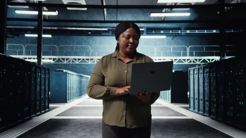 Programmer in Data Center Using Tablet to Increase Workload Capacity