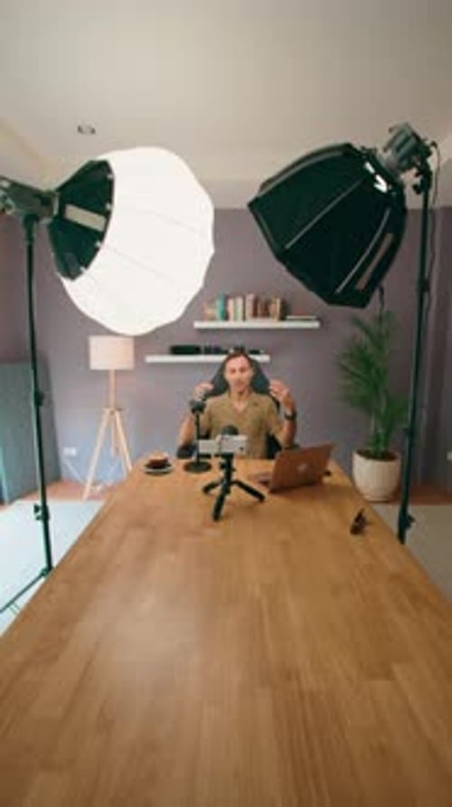 In the Studio Setup a Vlogger Uses Professional Lighting and Equipment for Creating Video Content