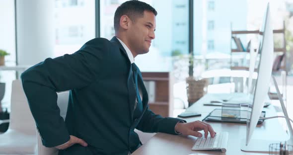 Computer, back pain and posture with a business man at his desk in the ...