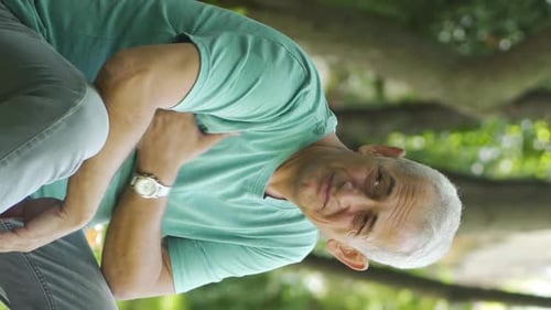 Vertical Video of The man who has the problem of sweat odor is disturbed by the situation.