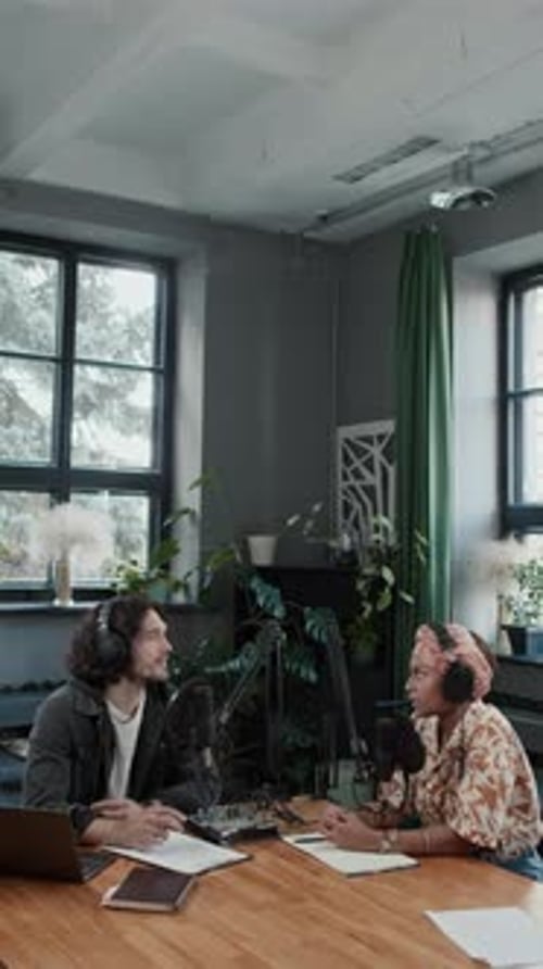 Vertical of Co-Hosts Recording Podcast in Studio