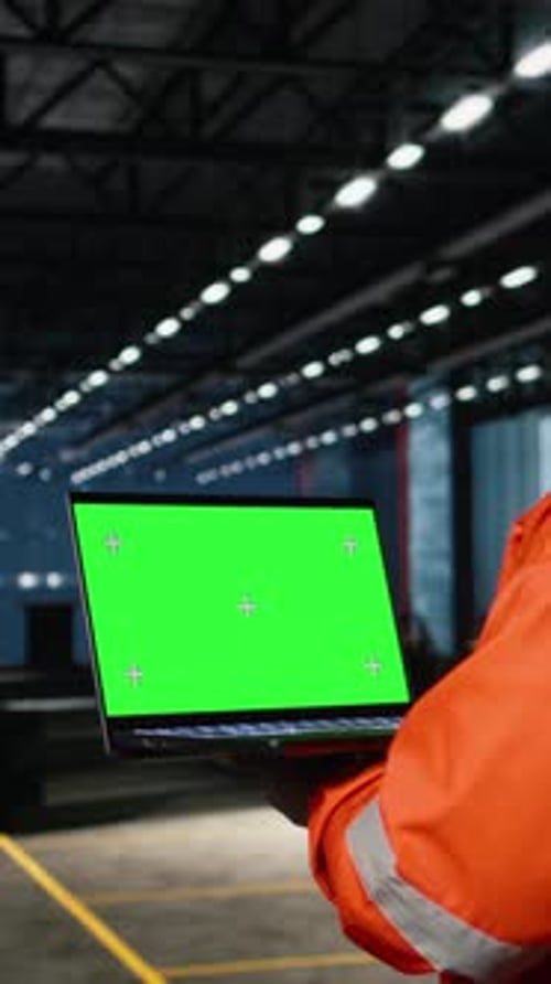 Vertical Video Green Screen Laptop with Black Technician Overseeing Fabrication Tasks