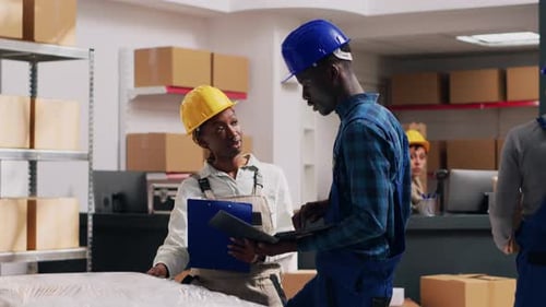 African American People Doing Quality Control in Warehouse