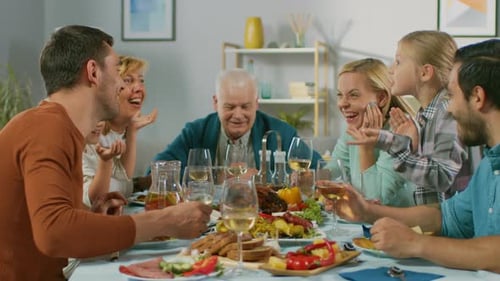 Family Gathered Together for Dinner Toasting Glasses