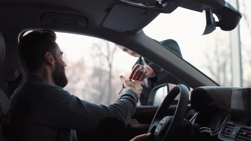 Young Attractive Man Sitting in Car's Interior Consultant of Car Dealer Giving Keys to Buyer Guy