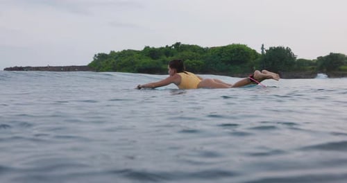 Young Surfer Woman with Perfect Body on Surfboard in Ocean with Waves