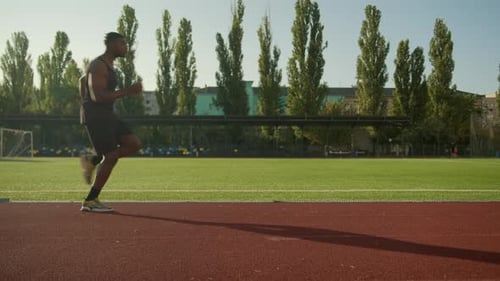 African American Man Runner Jogger Athlete Running on City Stadium High Legs Jogging Morning