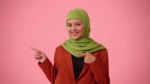 Woman in Hijab Points to the Left