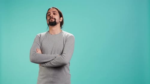 Man with Long Hair Poses in Studio