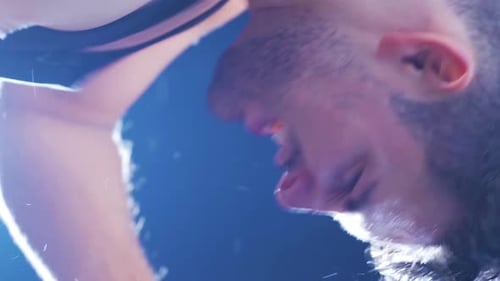 Vertikales Video eines männlichen Boxers in Nahaufnahme, der einen Boxsack schlägt.