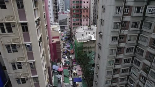 A Market in Hong Kong on a Narrow Street in the Middle of Skyscrapers