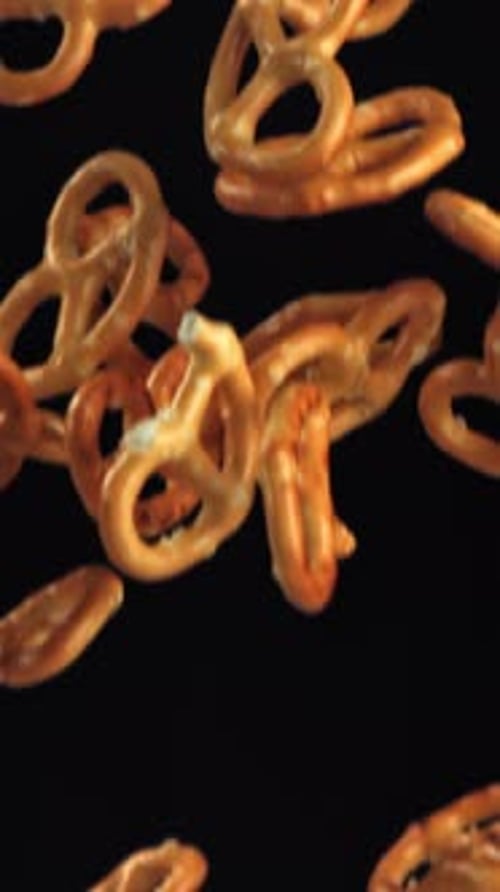 Salty Pretzels Fly and Fall on a Black Background Filmed on a Highspeed Camera at 1000 Fps