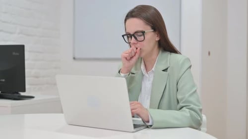 Woman Working on Laptop, Coughing into Hand
