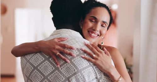 Smiling Woman Hugging Man Affectionately Inside Home