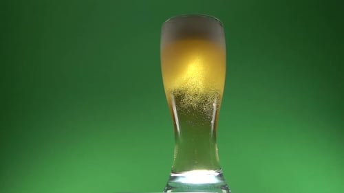 Refreshing Light Beer Being Poured on Green Screen