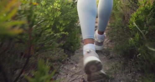 Running, fitness person and feet in nature on path for exercise, workout