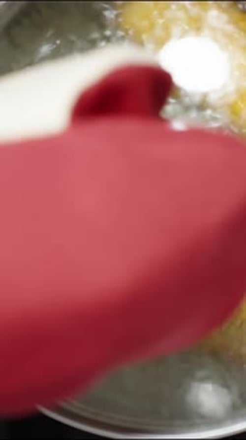 Vertical video. Using a red protective glove, I lift the hot lid of the pot in which corn is boiling