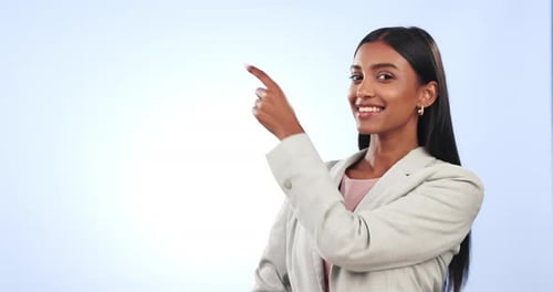 Happy business woman, pointing and list in advertising or marketing against a studio background