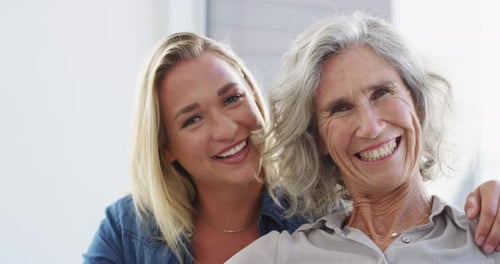 Smiling Mother and Daughter Embracing Close Up