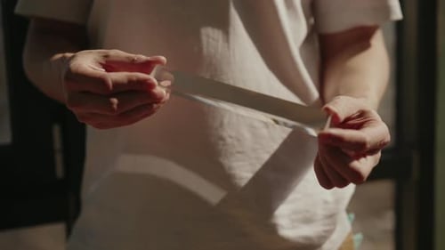 Cropped Shot of Man Holding Triangular Glass Prism Refracting Sunlight and Creating Rainbow Effect
