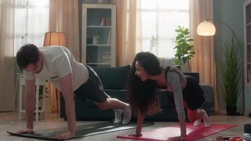 Couple Doing Mountain Climbers Exercise at Home