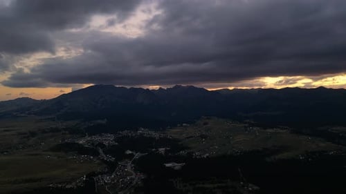 Bright sunset in the mountains. Red epic clouds. Aerial view.