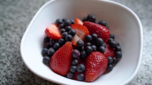 Bowl Of Fresh Blueberries And Strawberries. - close up
