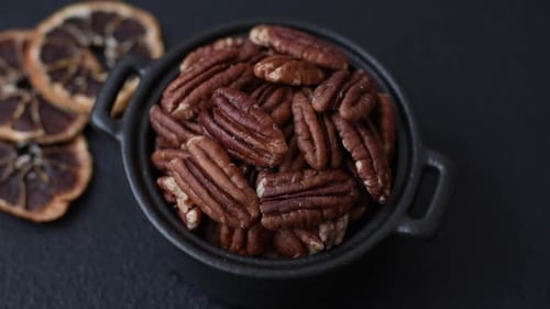 Peeled and roasted pecan nut as an ingredient for healthy food. Pecan nut as a food background