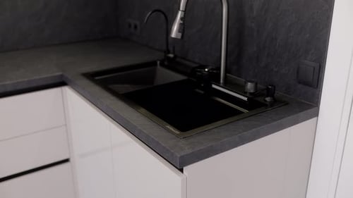 Modern Kitchen with Sleek Dark Countertop and White Cabinets