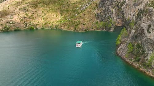 Aerial View Paddleboarding Adventure Through a Scenic Green Canyon in Nature