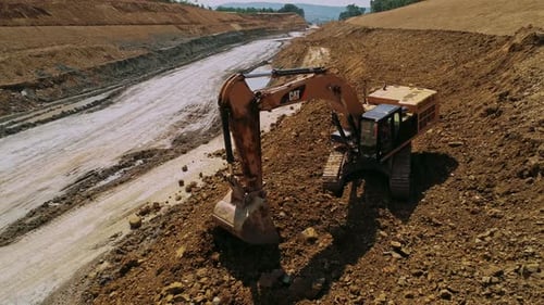 Excavator Digging Earth on Construction Site