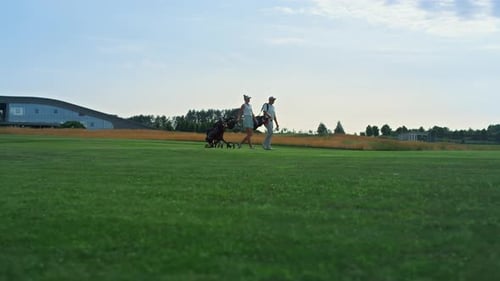 Golf Couple Walking Course Outdoors. Sport People Examine Country Club Fairway On